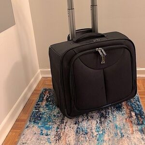 Travelpro suitcase! Carry on luggage with adjustable handle w/wheels. Used once!